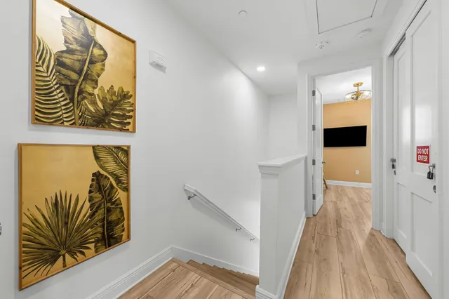 a living room with furniture a flat screen tv and a floor to ceiling window