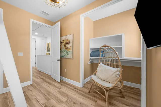 a bedroom with a bed and wooden floor