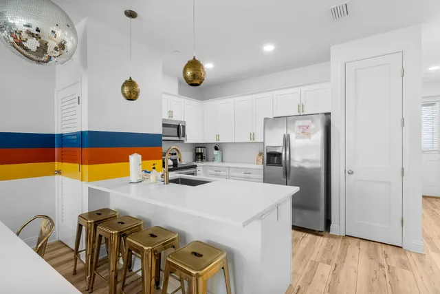 a bathroom with a sink a mirror toilet and shower