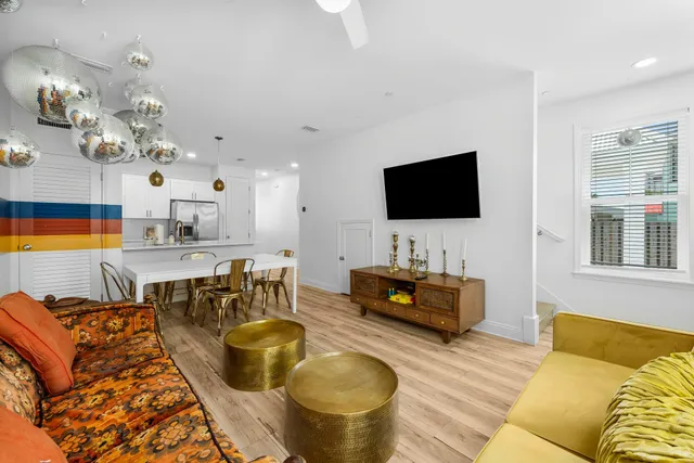 a living room with furniture and wooden floor