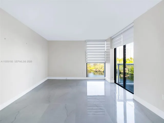 a view of an empty room and a window
