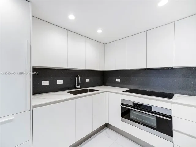 a kitchen with a sink and cabinets