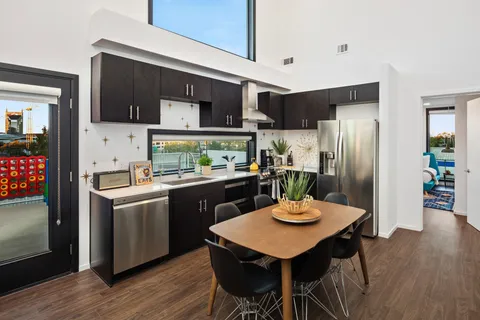 a kitchen with stainless steel appliances granite countertop a kitchen island hardwood floor and center island