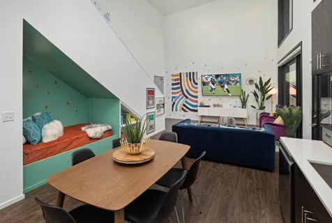 a view of a dining room with furniture and chandelier