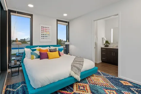 a bedroom with a bed and a dresser