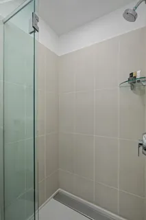 a bathroom with a shower and a toilet