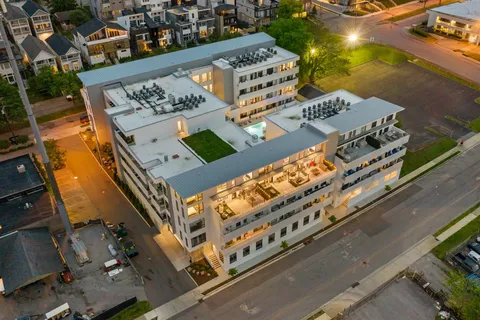 a view of a large building with a swimming pool