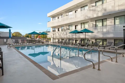 a view of a swimming pool with chairs