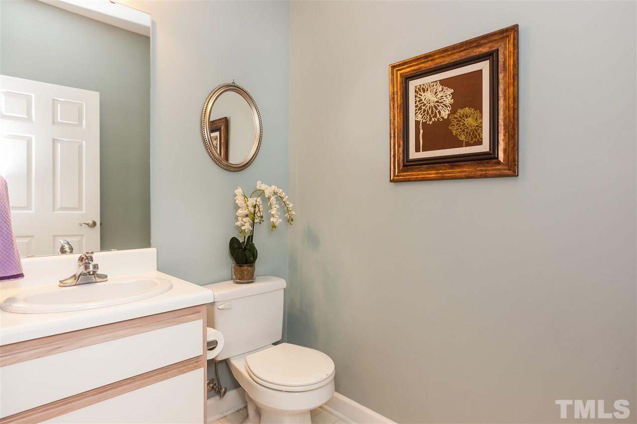 2608 Sterling Park Drive Raleigh, NC 27603 - Photo 12 of 21 a bathroom with a toilet a sink and a mirror