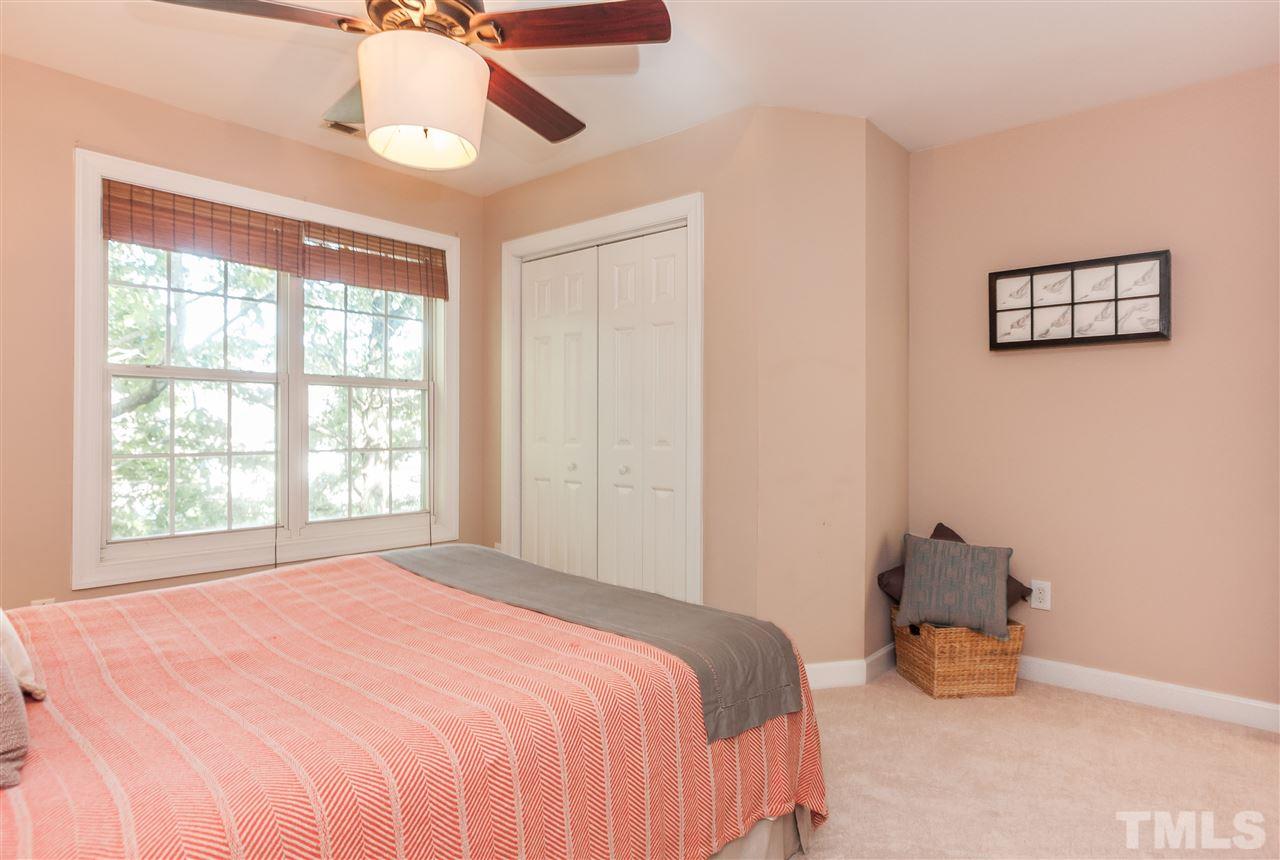 2608 Sterling Park Drive Raleigh, NC 27603 - Photo 13 of 21 a bedroom with a bed and a chandelier