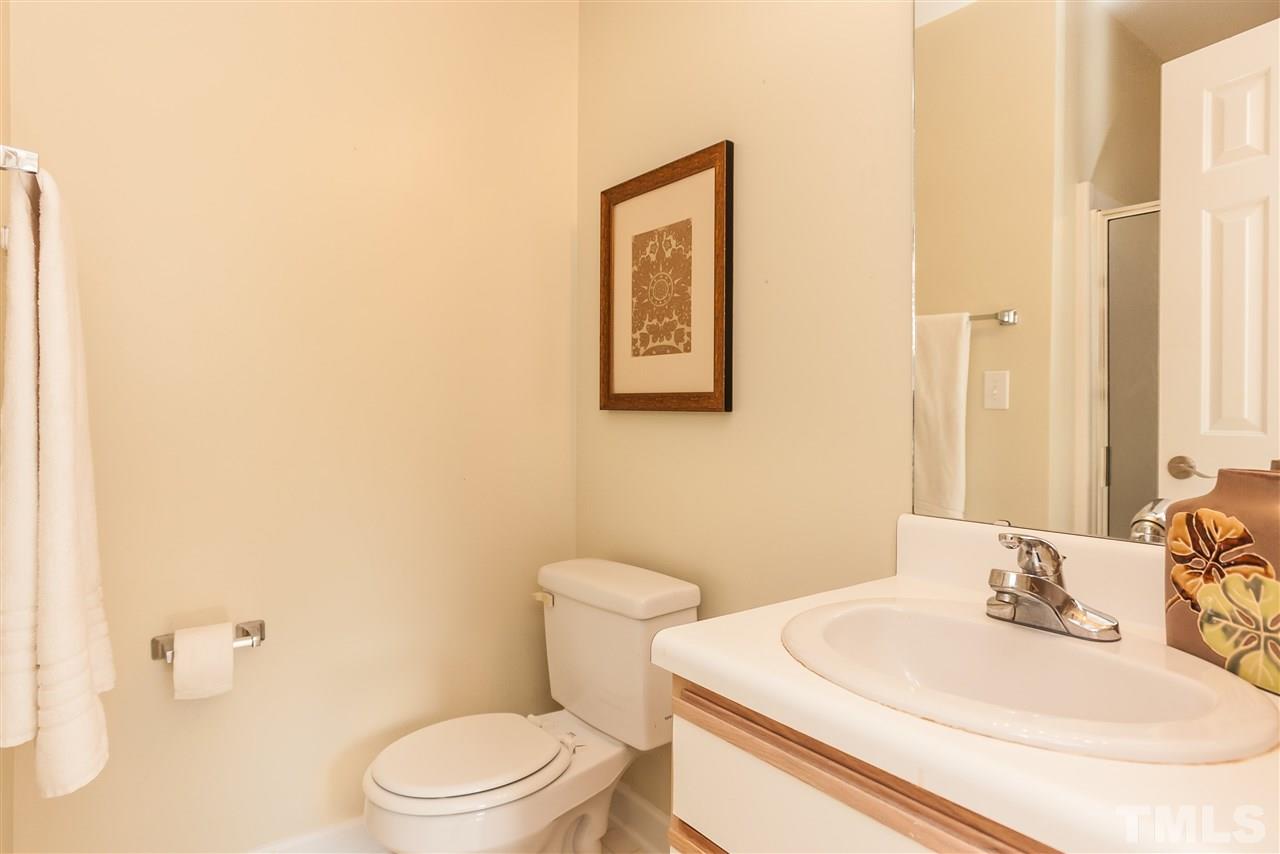 2608 Sterling Park Drive Raleigh, NC 27603 - Photo 15 of 21 a bathroom with a sink a toilet and a mirror