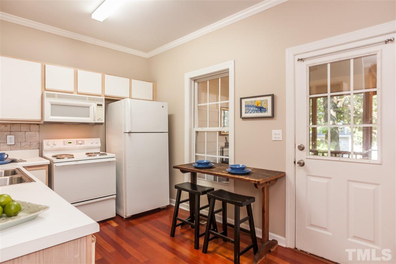 2608 Sterling Park Drive Raleigh, NC 27603 - Photo 6 of 21 a kitchen with stainless steel appliances a refrigerator a stove a dining table and chairs