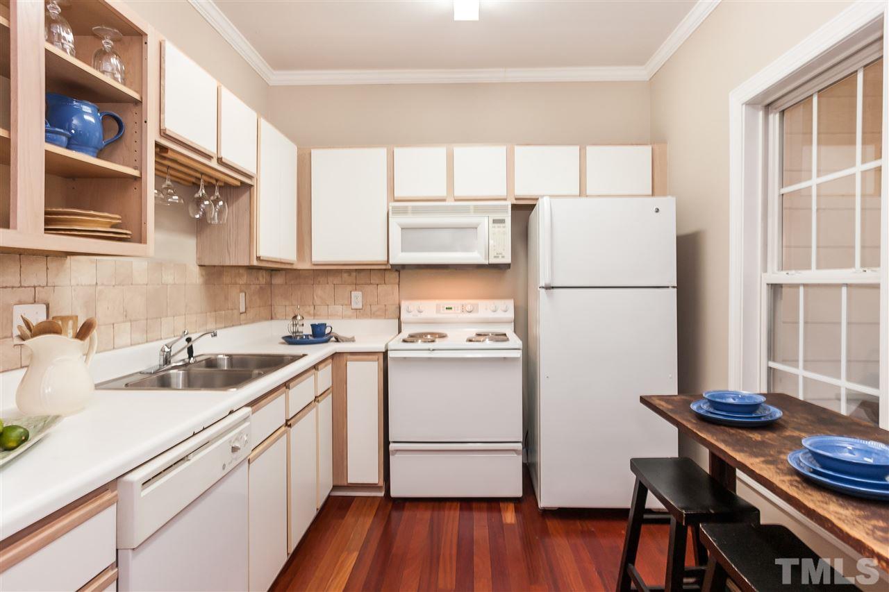 2608 Sterling Park Drive Raleigh, NC 27603 - Photo 7 of 21 a kitchen with a refrigerator a sink and cabinets