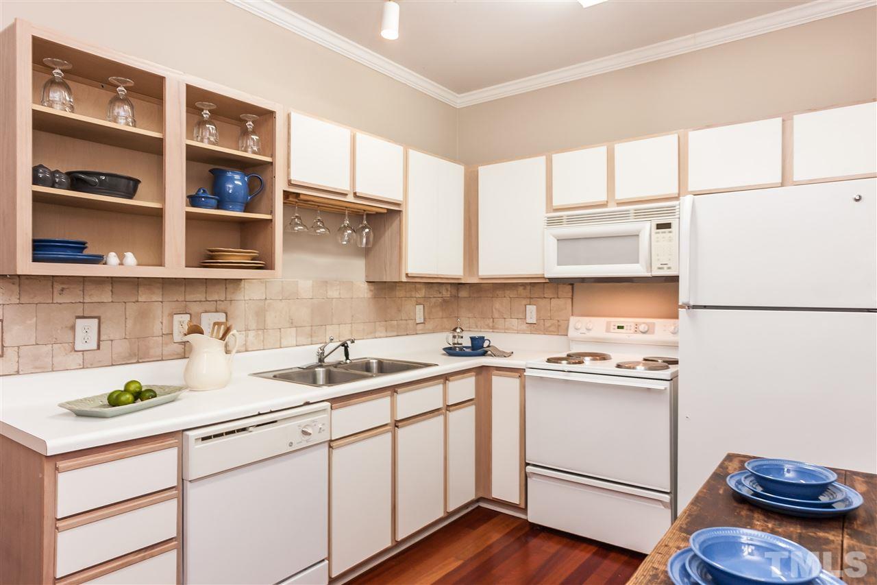 2608 Sterling Park Drive Raleigh, NC 27603 - Photo 8 of 21 a kitchen with a sink a cabinets and window