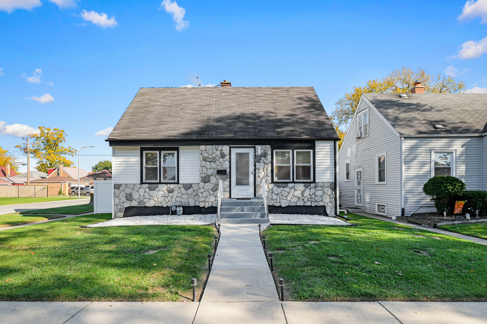 14301 Parnell Avenue Harvey, IL 60426 - Photo 1 of 17 a front view of a house with a garden and yard