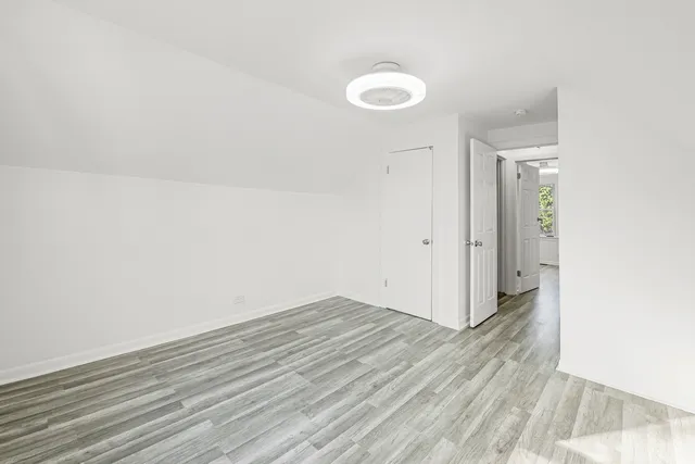 a view of a room with wooden floor