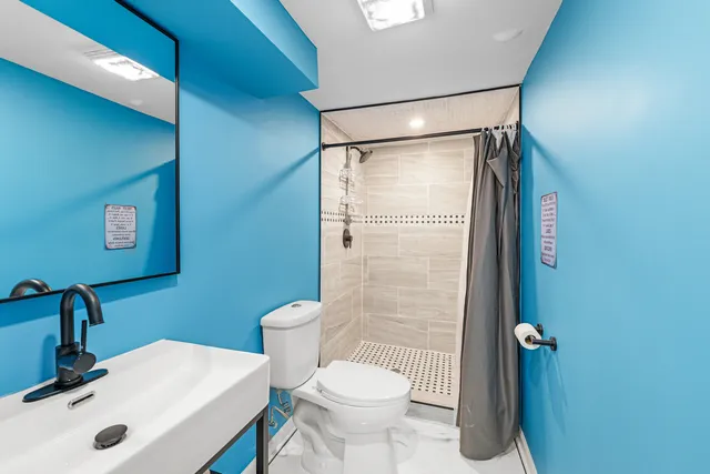 a bathroom with a sink toilet and shower