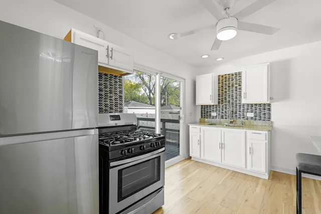 a kitchen with stainless steel appliances granite countertop a stove and a refrigerator