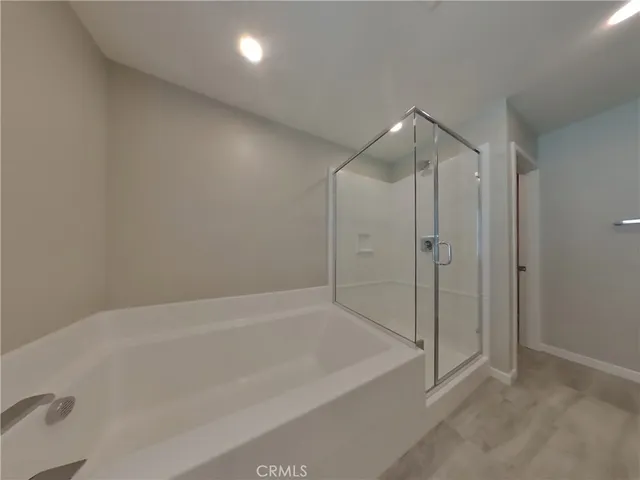 a spacious bathroom with a bathtub and a shower