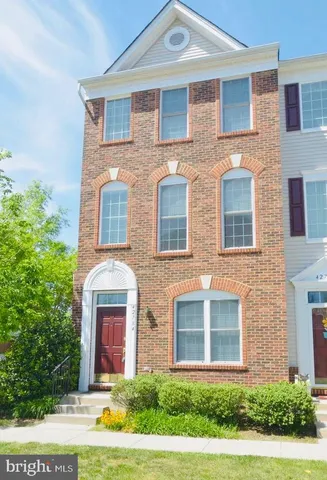 a front view of a brick house with a yard