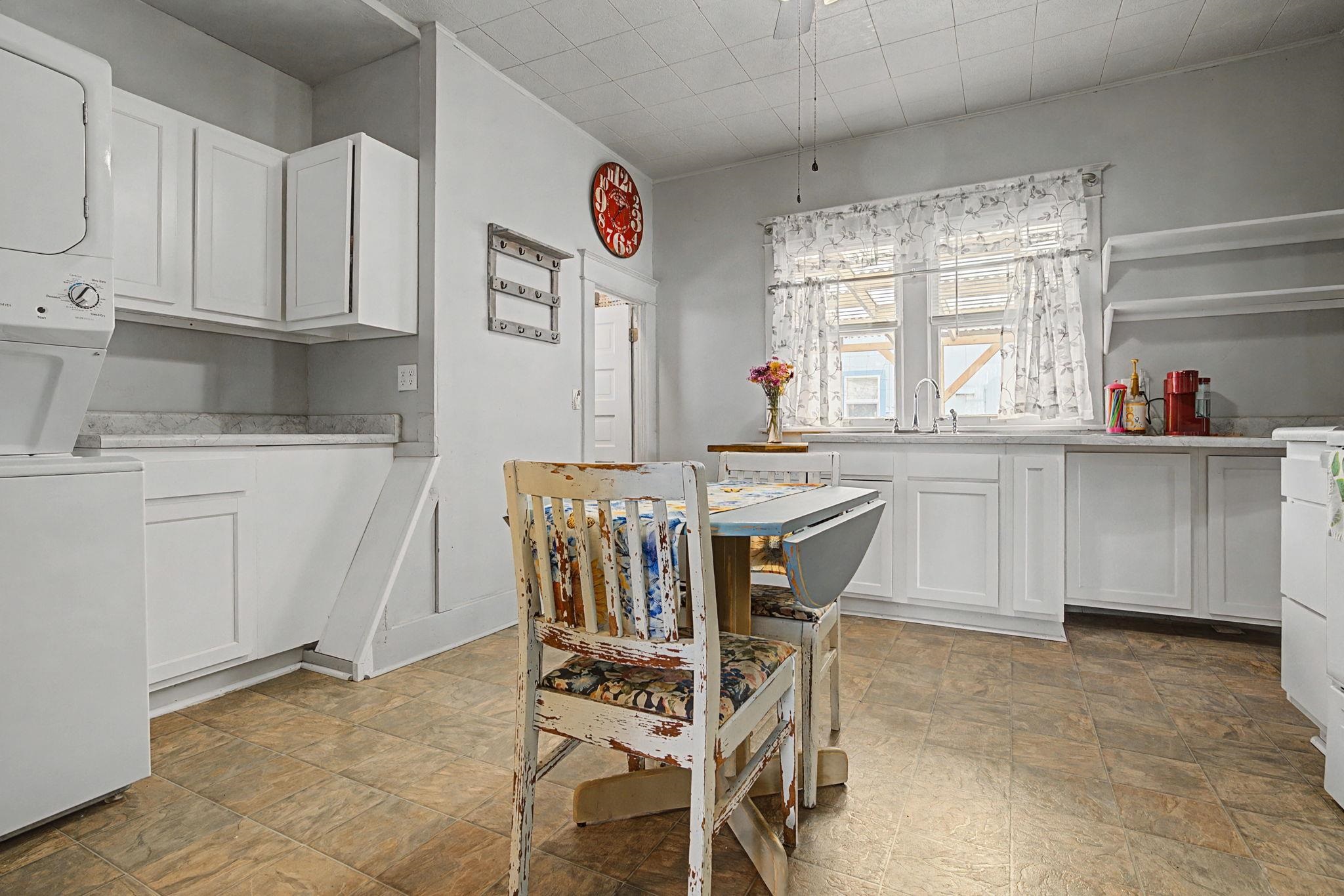 216 4th Street Clifton, CO 81520 - Photo 7 of 17 a kitchen with stainless steel appliances a white table and chairs in it