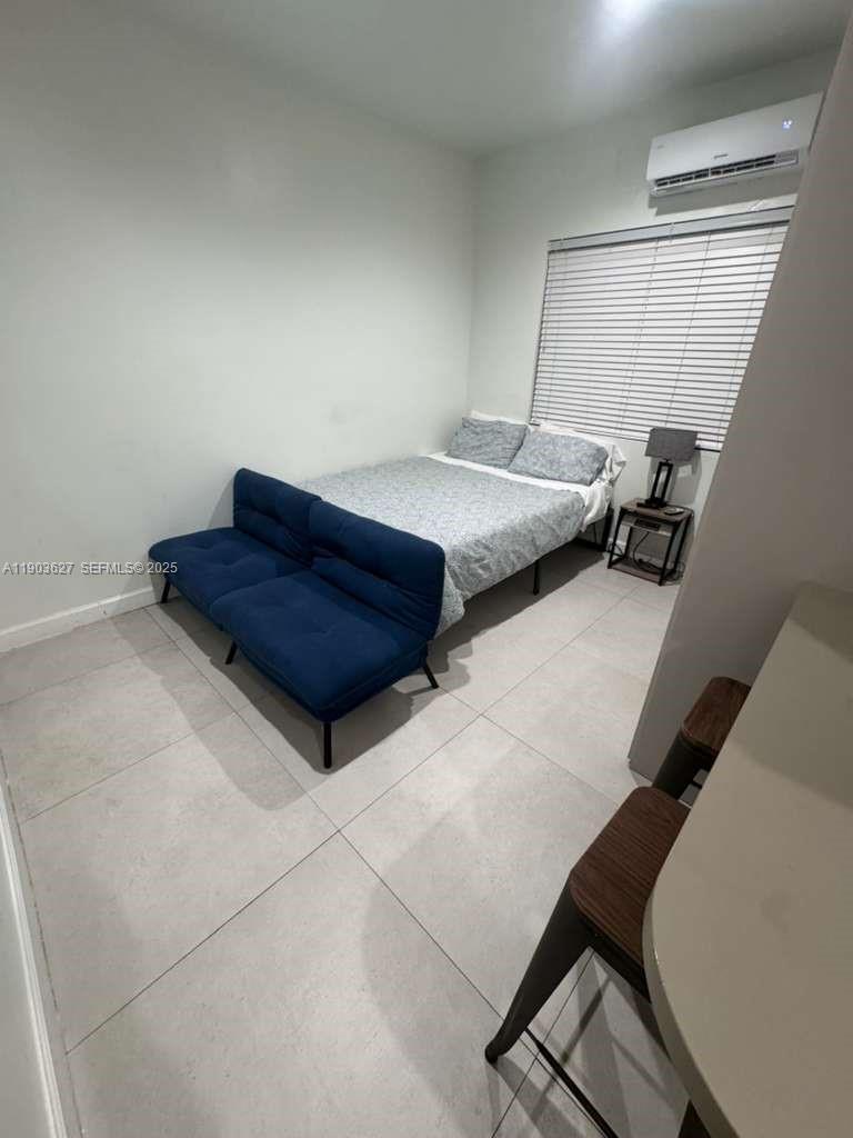 245 Northeast 33rd Street, Unit 106 Miami, FL 33137 - Photo 1 of 13 a bedroom with a bed and a window