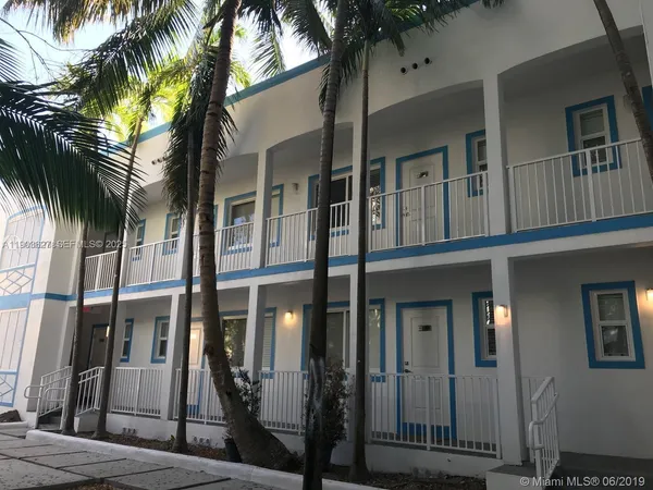 a view of a house with a palm tree