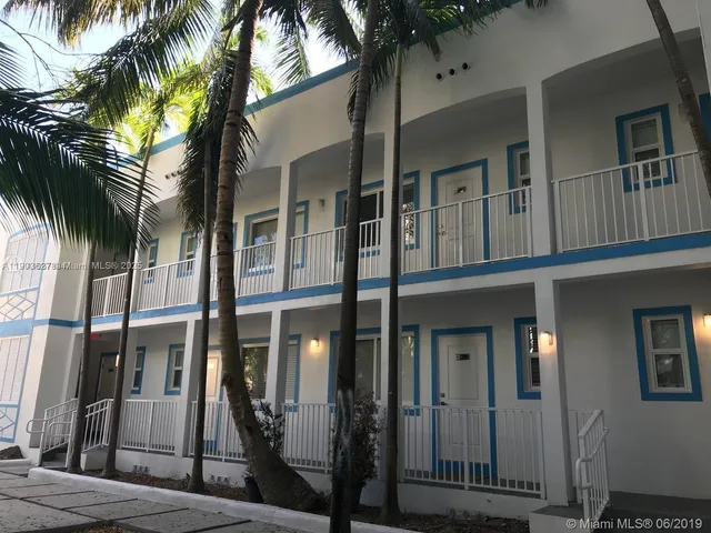 a view of a house with a palm tree