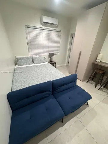 a living room with furniture and a mirror