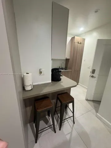 a view of a workspace with furniture and wooden floor