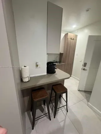 a view of a workspace with furniture and wooden floor
