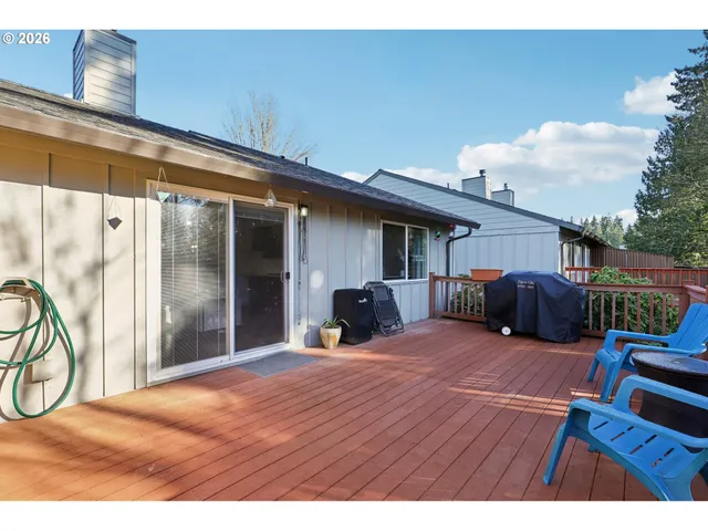 a bedroom with furniture and a large window