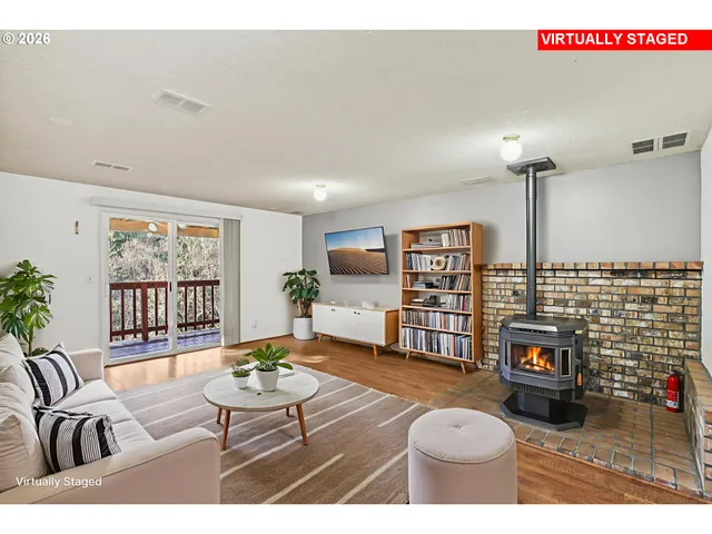 a living room with furniture a rug and a fireplace