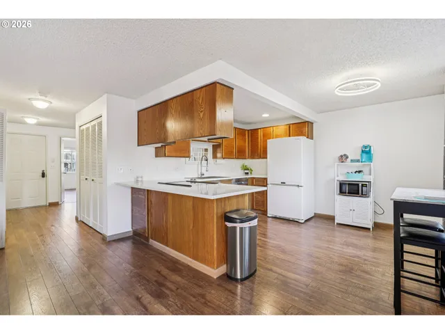 a kitchen with stainless steel appliances a refrigerator and a stove top oven