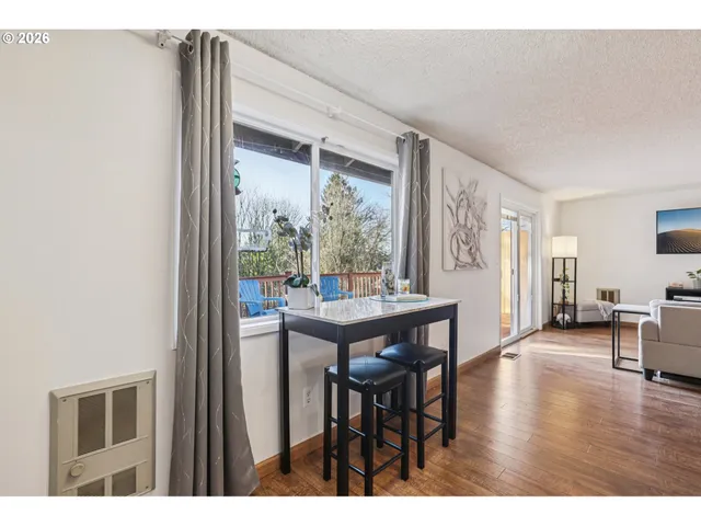 a dining room with furniture and wooden floor