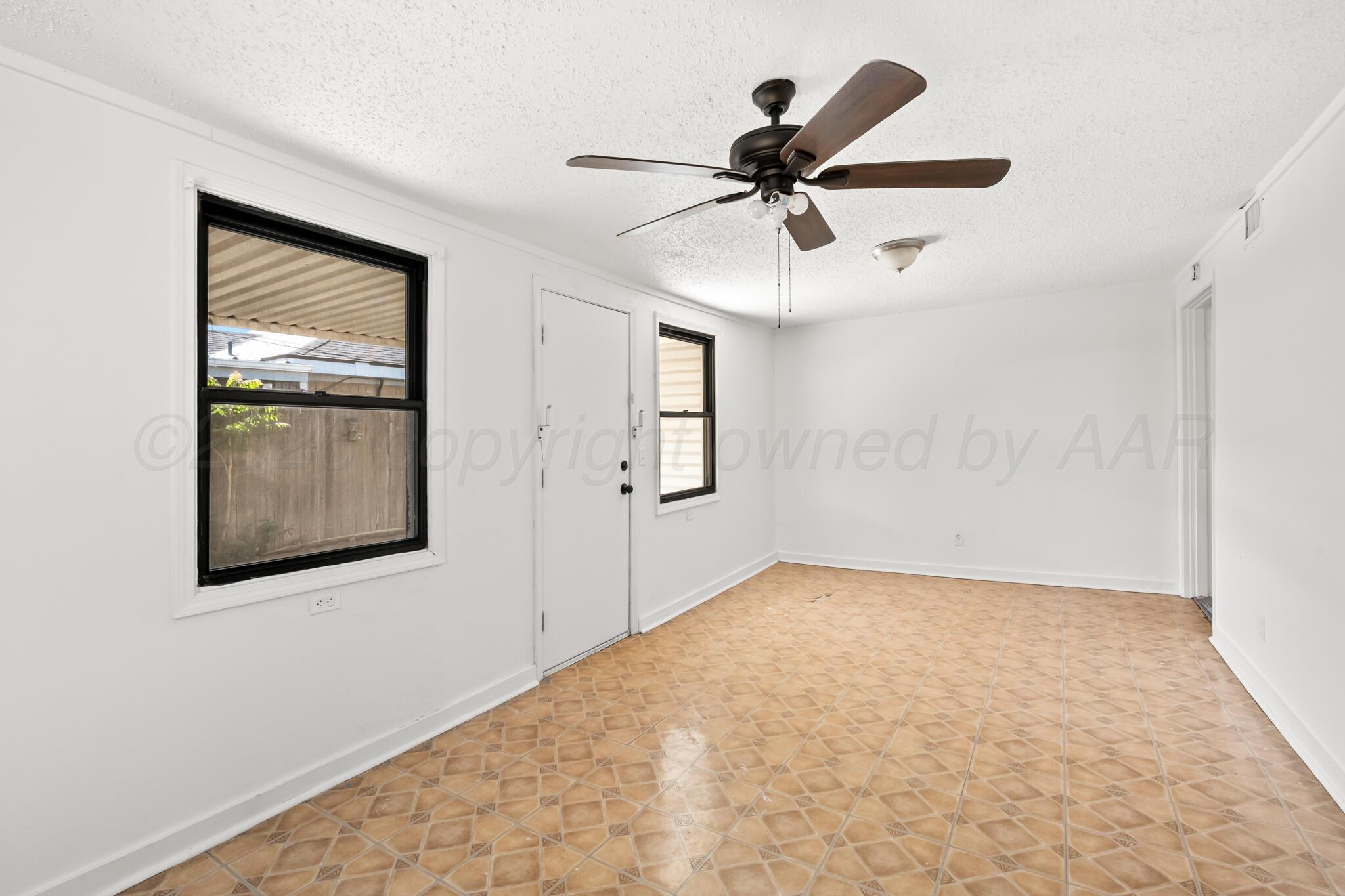 2708 Salem Drive Amarillo, TX 79110 - Photo 8 of 21 a view of a big room with wooden floor and windows