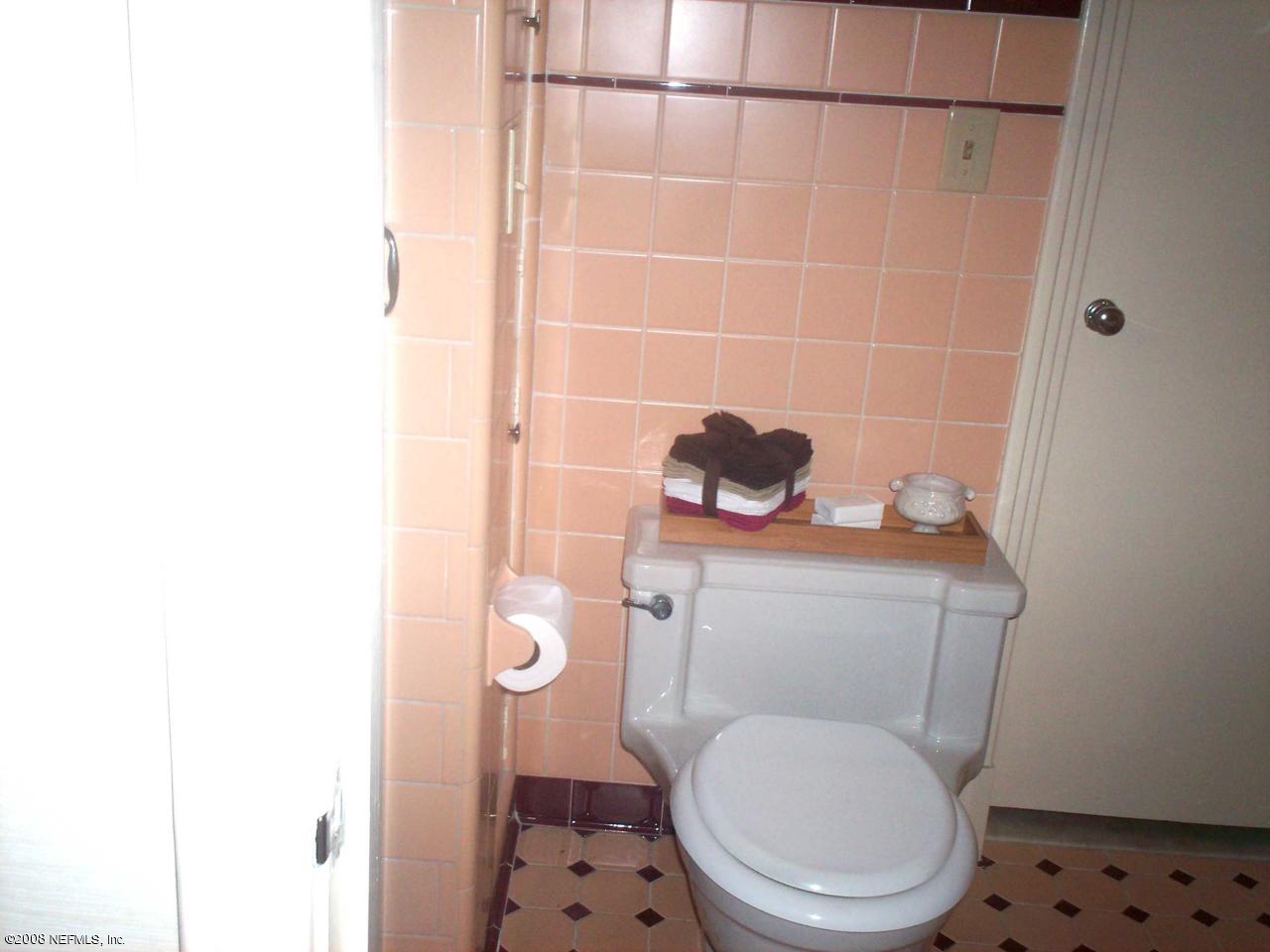 906 Waterman Road North Jacksonville, FL 32207 - Photo 13 of 23 a white toilet sitting next to a bathroom sink