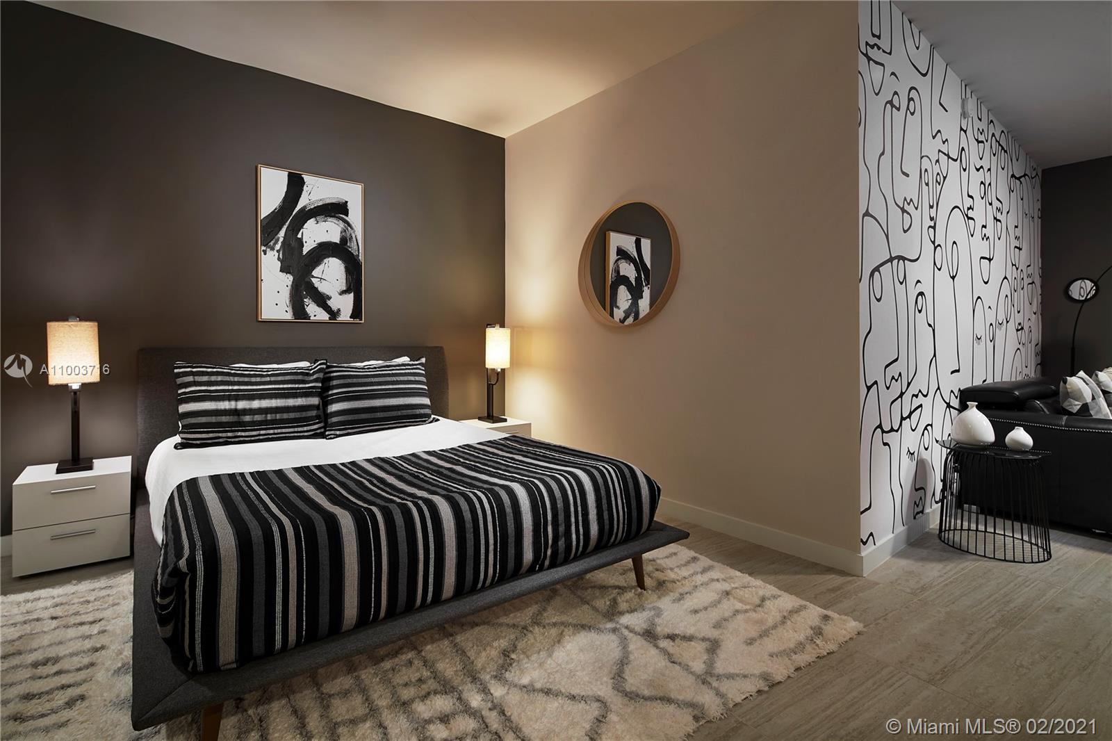 3900 Biscayne Boulevard, Unit N723 Miami, FL 33137 - Photo 1 of 15 a bedroom with a bed and painting on the wall
