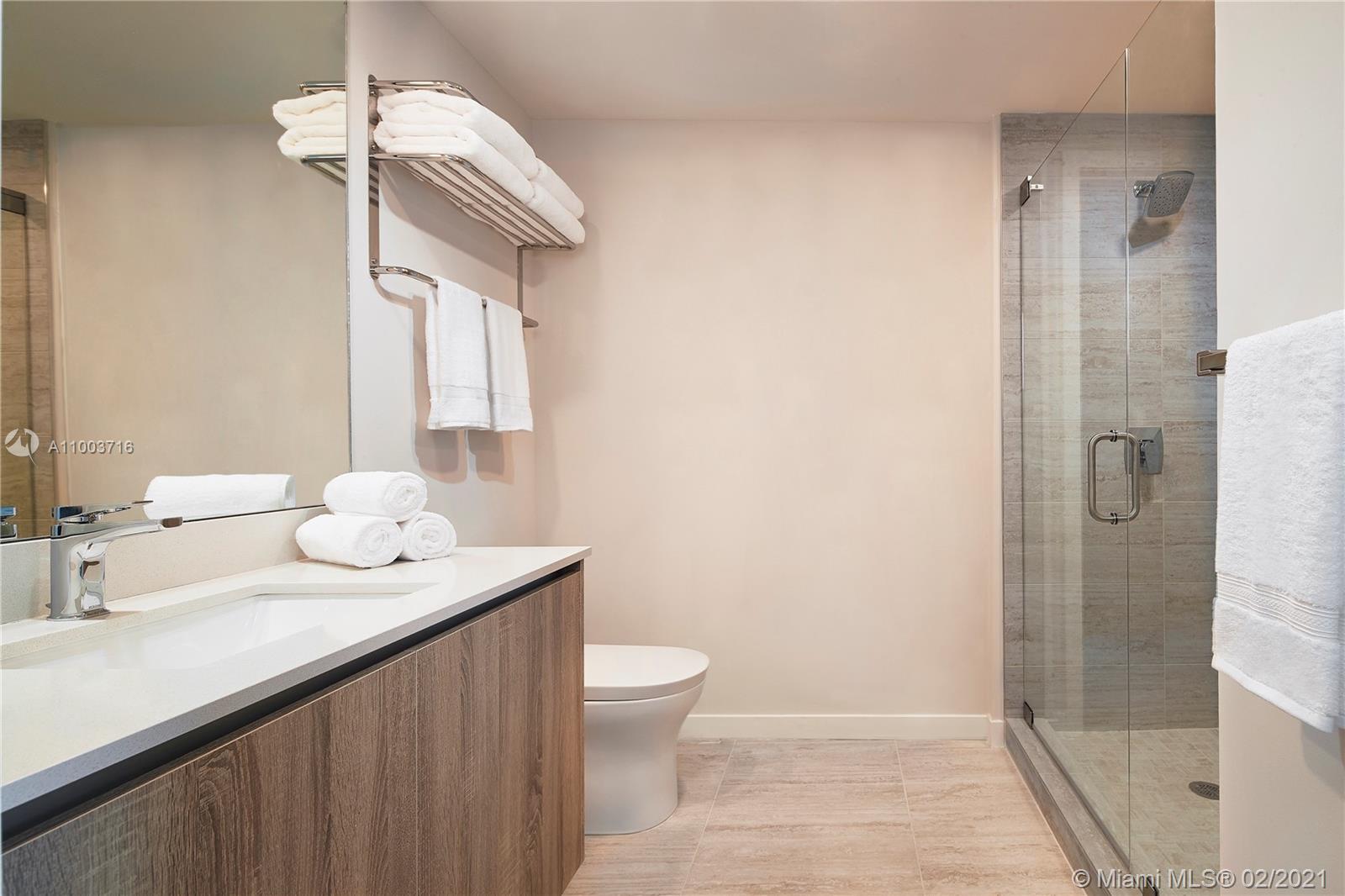 3900 Biscayne Boulevard, Unit N723 Miami, FL 33137 - Photo 11 of 15 a bathroom with a sink a toilet and shower
