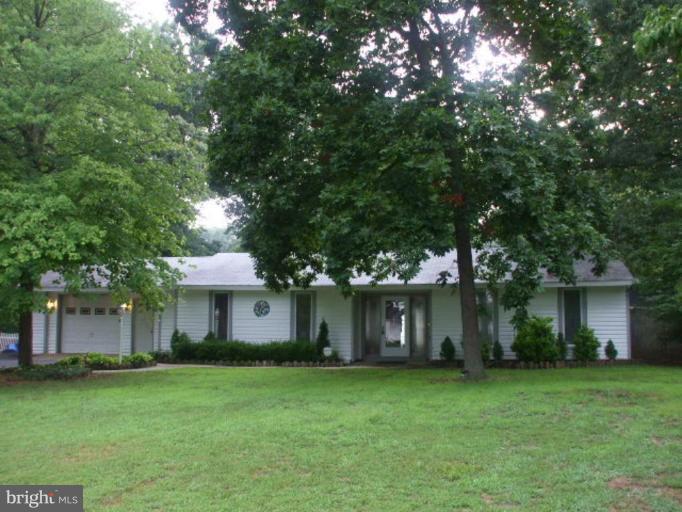 5007 Decatur Street St. Leonard, MD 20685 - Photo 1 of 17 a front view of a house with a garden