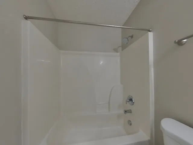 a bathroom with a shower and a bath tub