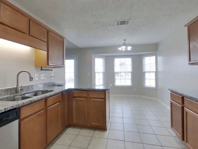 a kitchen with a sink cabinets and window
