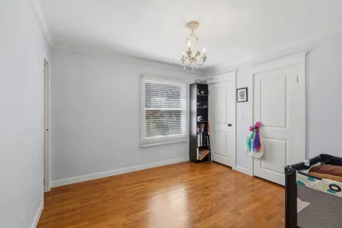 a view of a patio with table and chairs potted plants and large tree
