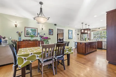 a view of a dining room with furniture and a chandelier