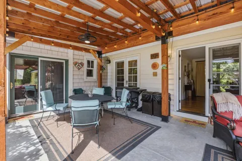 a view of a patio with table and chairs and potted plants