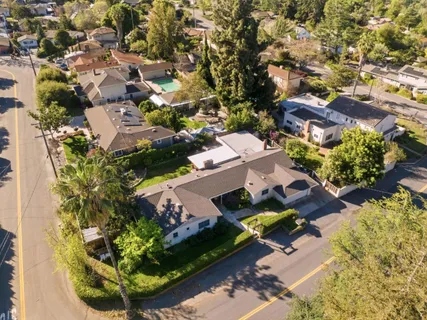 an aerial view of residential houses with outdoor space