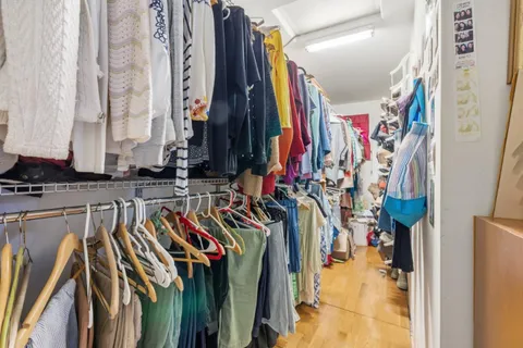 a view of walk in closet with clothes