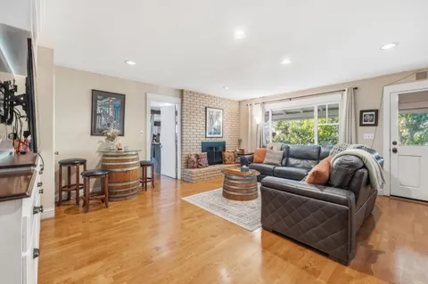 a kitchen with stainless steel appliances granite countertop a refrigerator a stove and a wooden floors