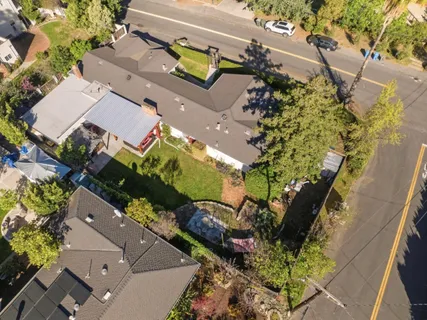 an aerial view of a house with a yard and a garden
