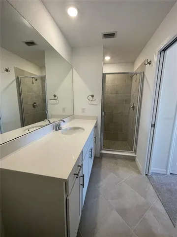 an empty room with a ceiling fan and window